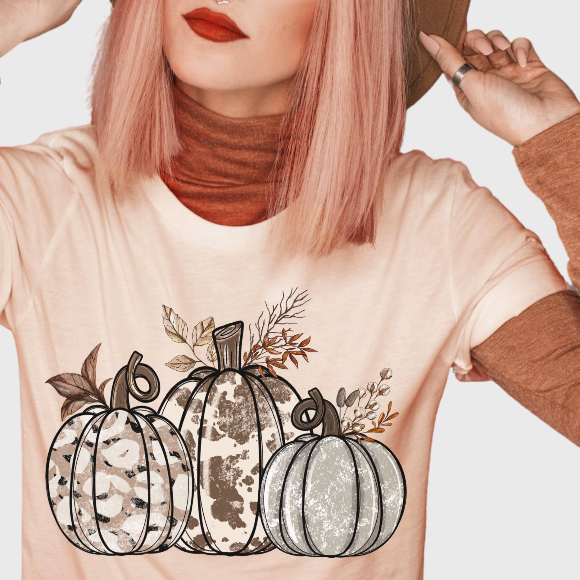 Peach tee with leopard / cow print pumpkins