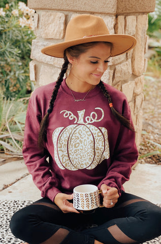 Modern pumpkin on maroon sweater